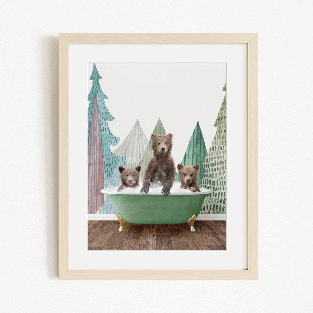 A framed print depicting three bears sitting in a green bathtub, with a forest scene in the background.