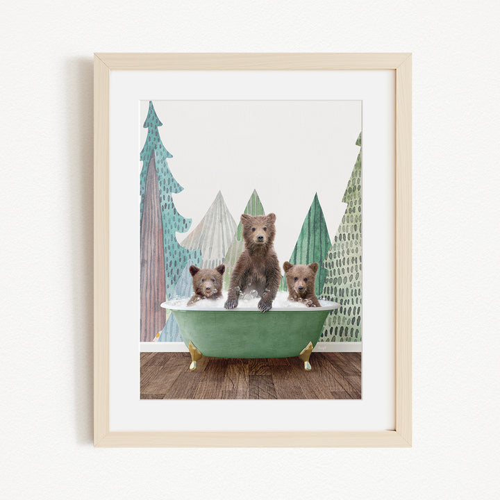 A framed print depicting three bears sitting in a green bathtub, with a forest scene in the background.