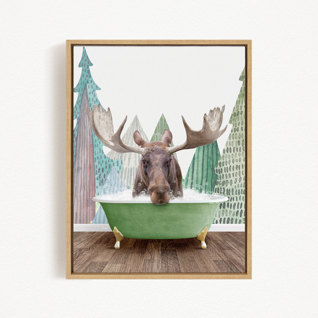 A moose with large antlers is sitting in a green bathtub, surrounded by a forest scene with trees and a snowy landscape.
