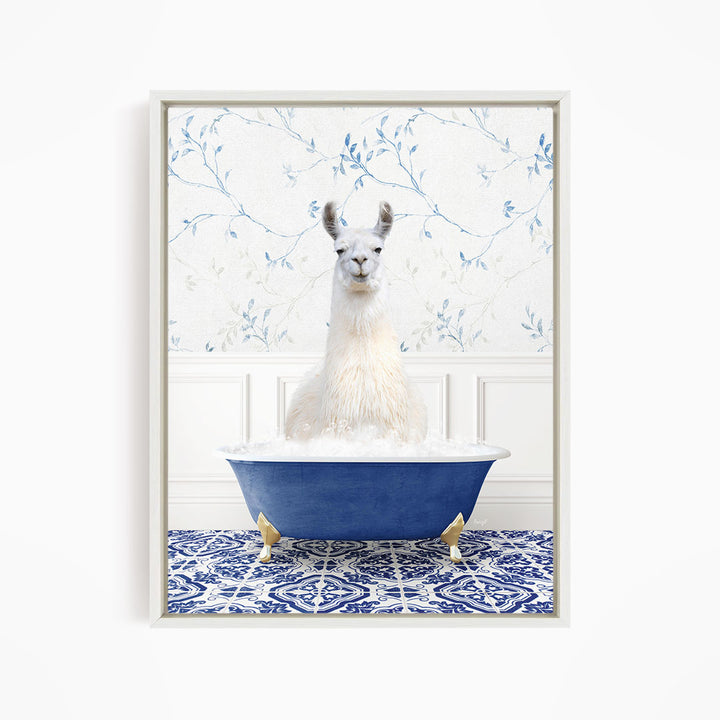 A white llama sitting in a blue bathtub filled with bubbles, surrounded by a blue and white patterned tile floor.