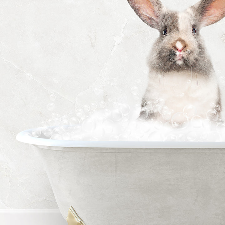 a rabbit is sitting in a bathtub full of bubbles