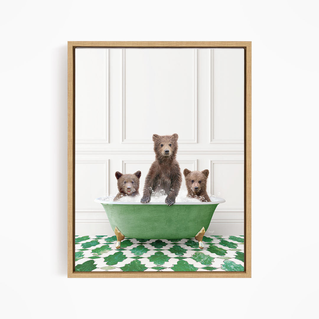 A framed image depicting three bears sitting in a green bathtub filled with water, with a patterned green and white floor beneath them.