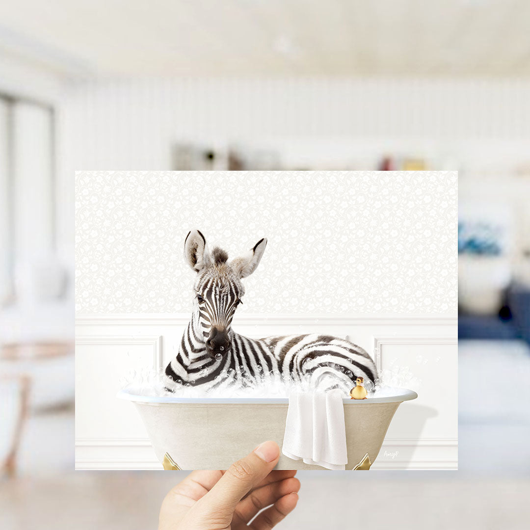 A zebra sitting in a bathtub filled with water, surrounded by a towel and a small toy.