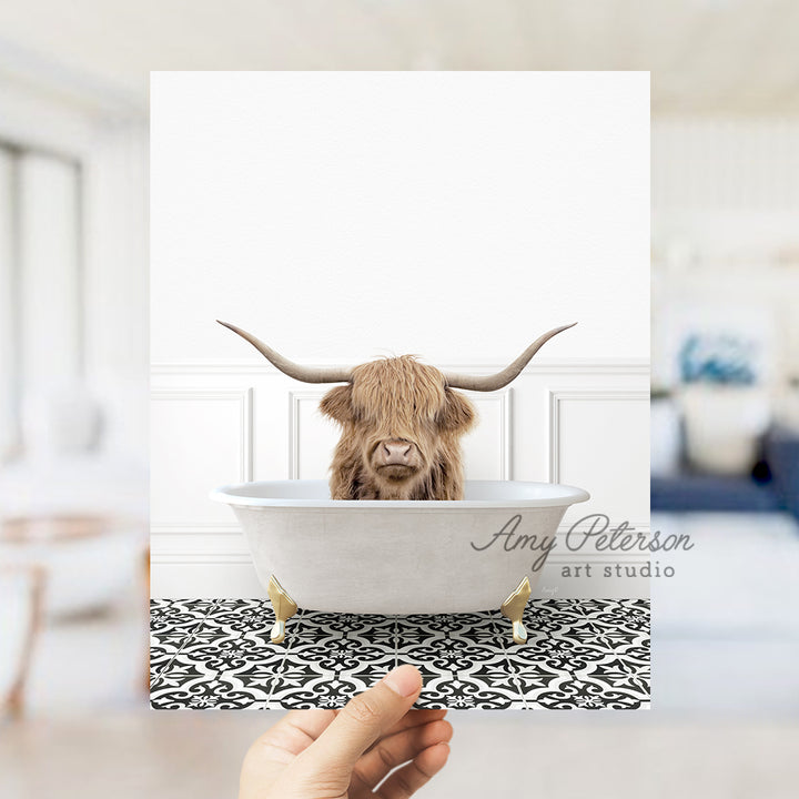 a hand holding up a card with a picture of a bull in a bathtub