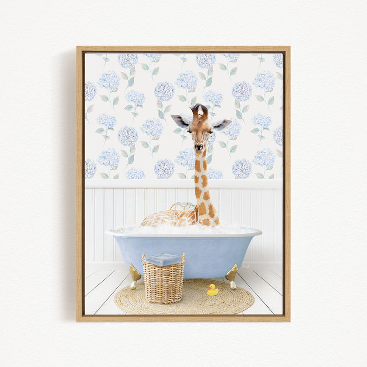 A giraffe is sitting in a blue bathtub filled with water, surrounded by a wicker basket and a yellow rubber duck.