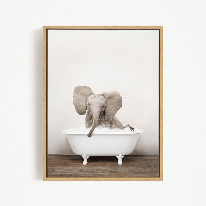 A baby elephant sitting in a white bathtub filled with water, with its trunk submerged in the water.