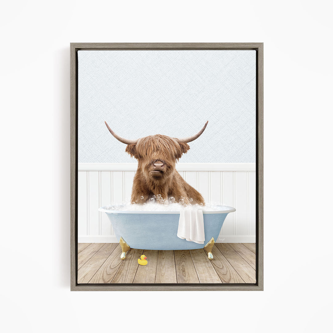 A brown cow with long horns is sitting in a blue bathtub filled with water, surrounded by rubber ducks.