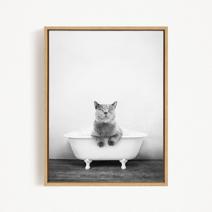 A gray cat sitting in a white bathtub, with its eyes closed, creating a serene and peaceful scene.