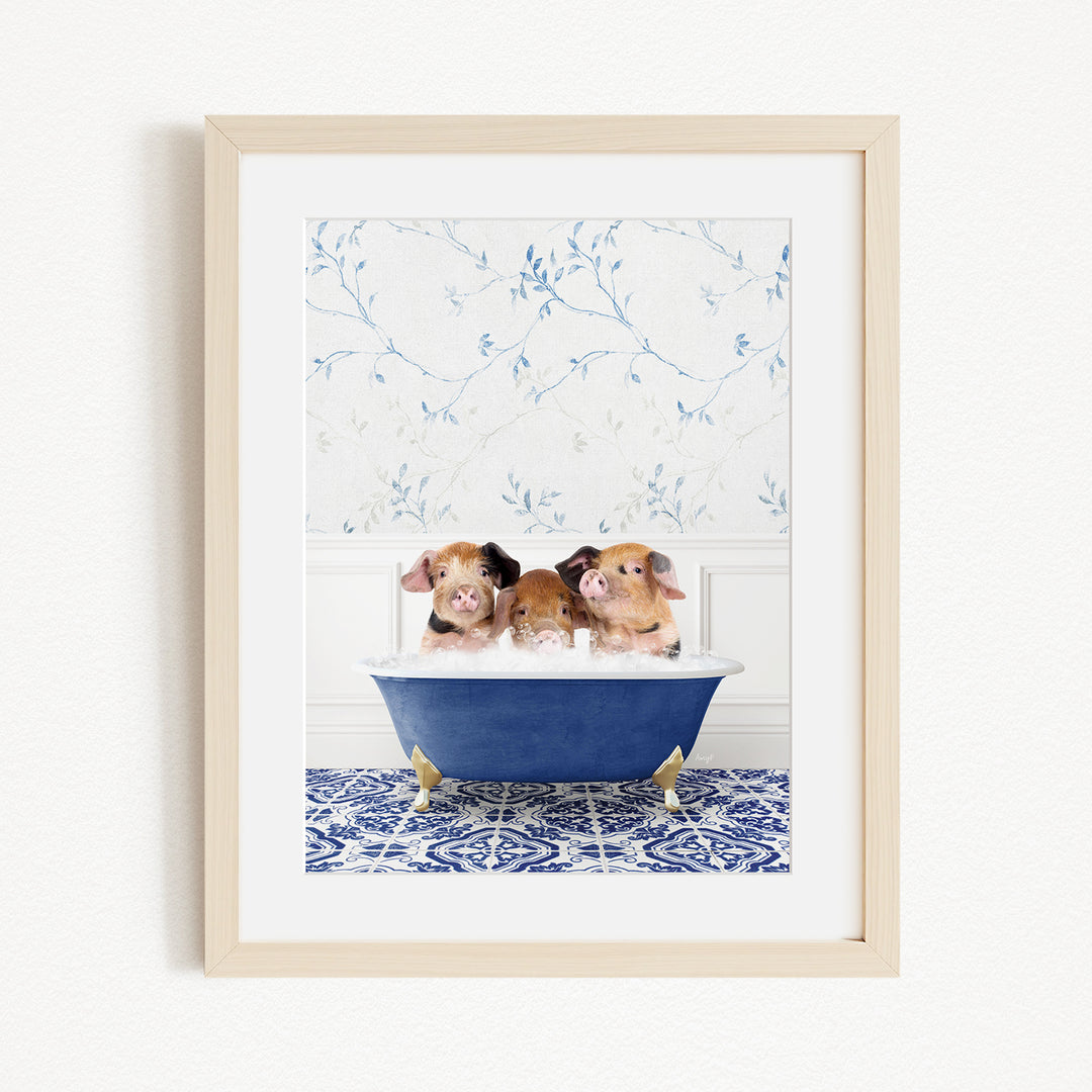 Three adorable pigs sitting in a blue bathtub, with a floral patterned wall behind them.