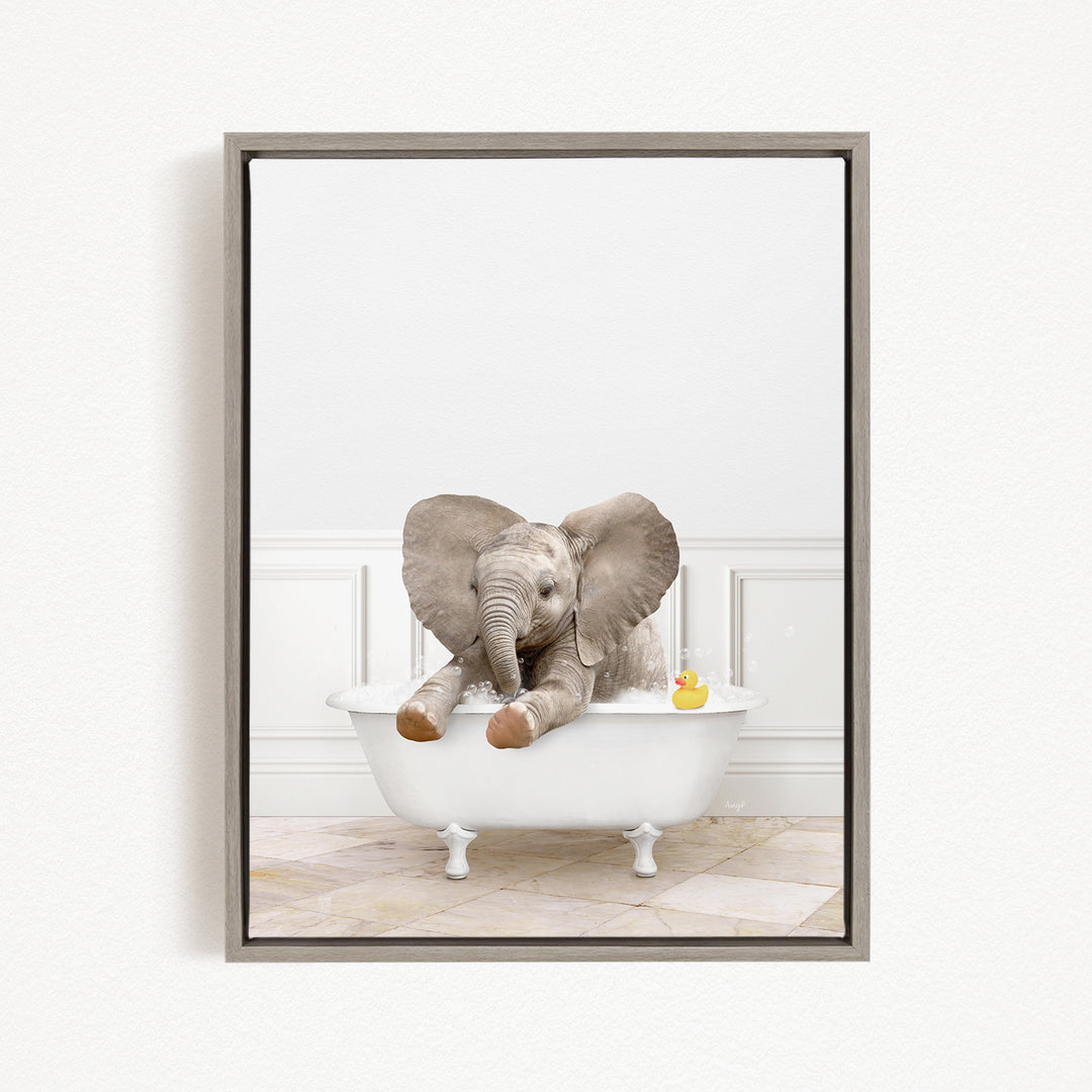 A gray elephant is sitting in a white bathtub, with a yellow rubber duck floating on the water.