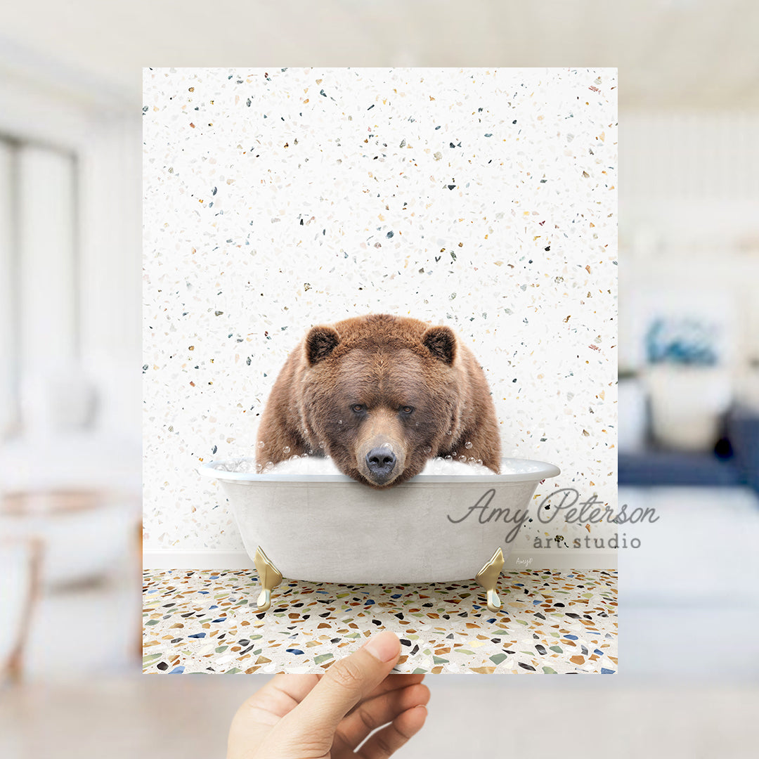 a hand holding up a card with a bear in a bathtub