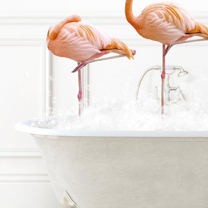 two pink flamingos standing in a bathtub filled with bubbles