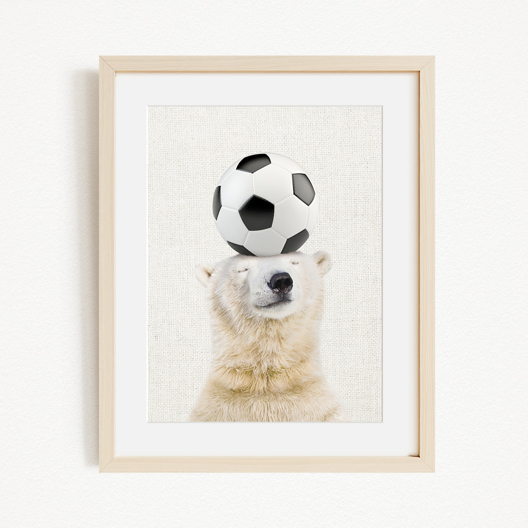 A polar bear balancing a soccer ball on its head.