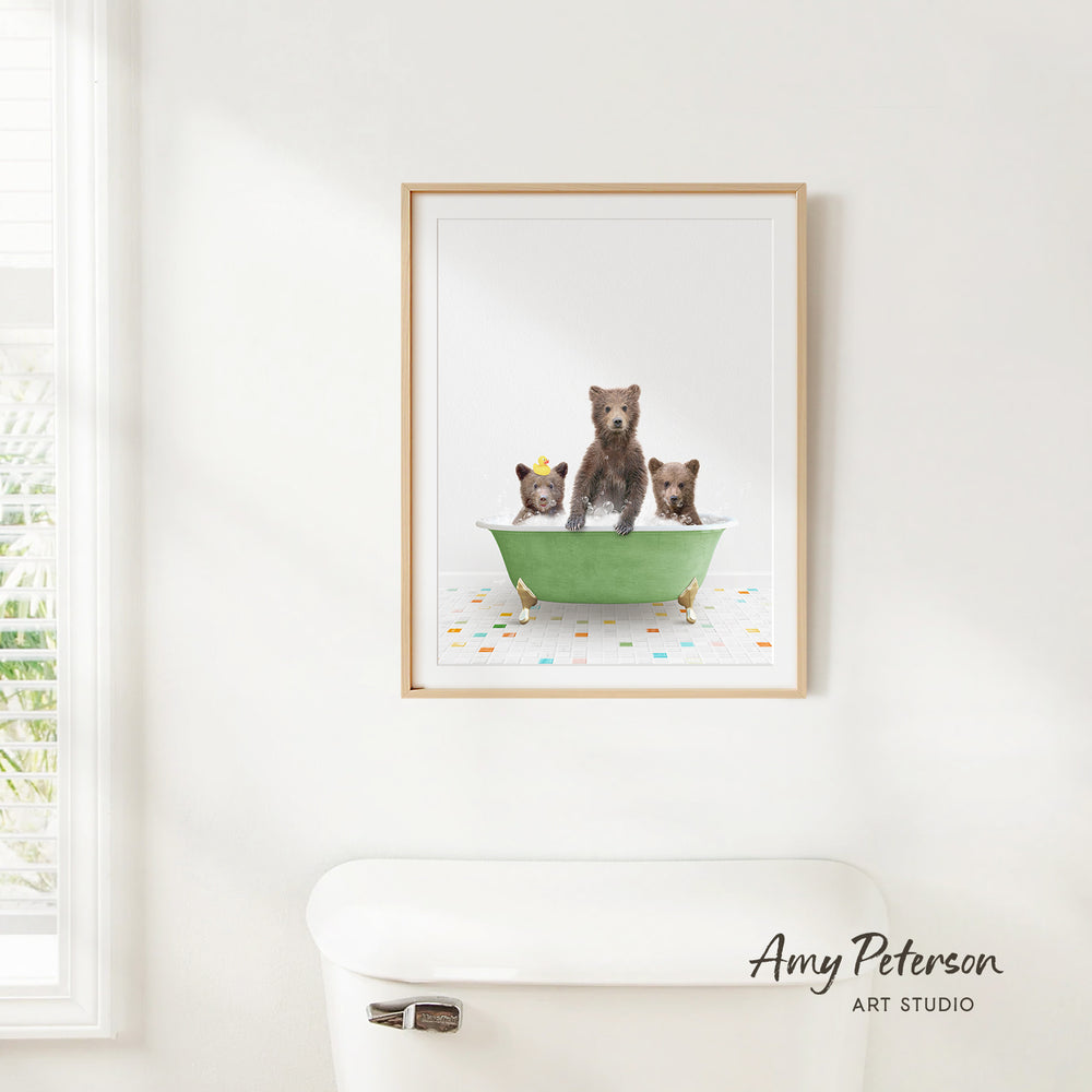 A framed image of three bears sitting in a green bathtub, with one bear standing on its hind legs and the other two sitting comfortably.