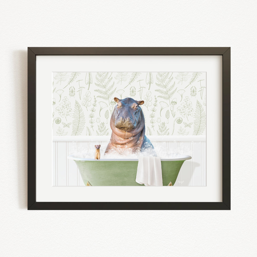 A hippopotamus sitting in a green bathtub, surrounded by a towel and a small animal, against a backdrop of green ferns and leaves.