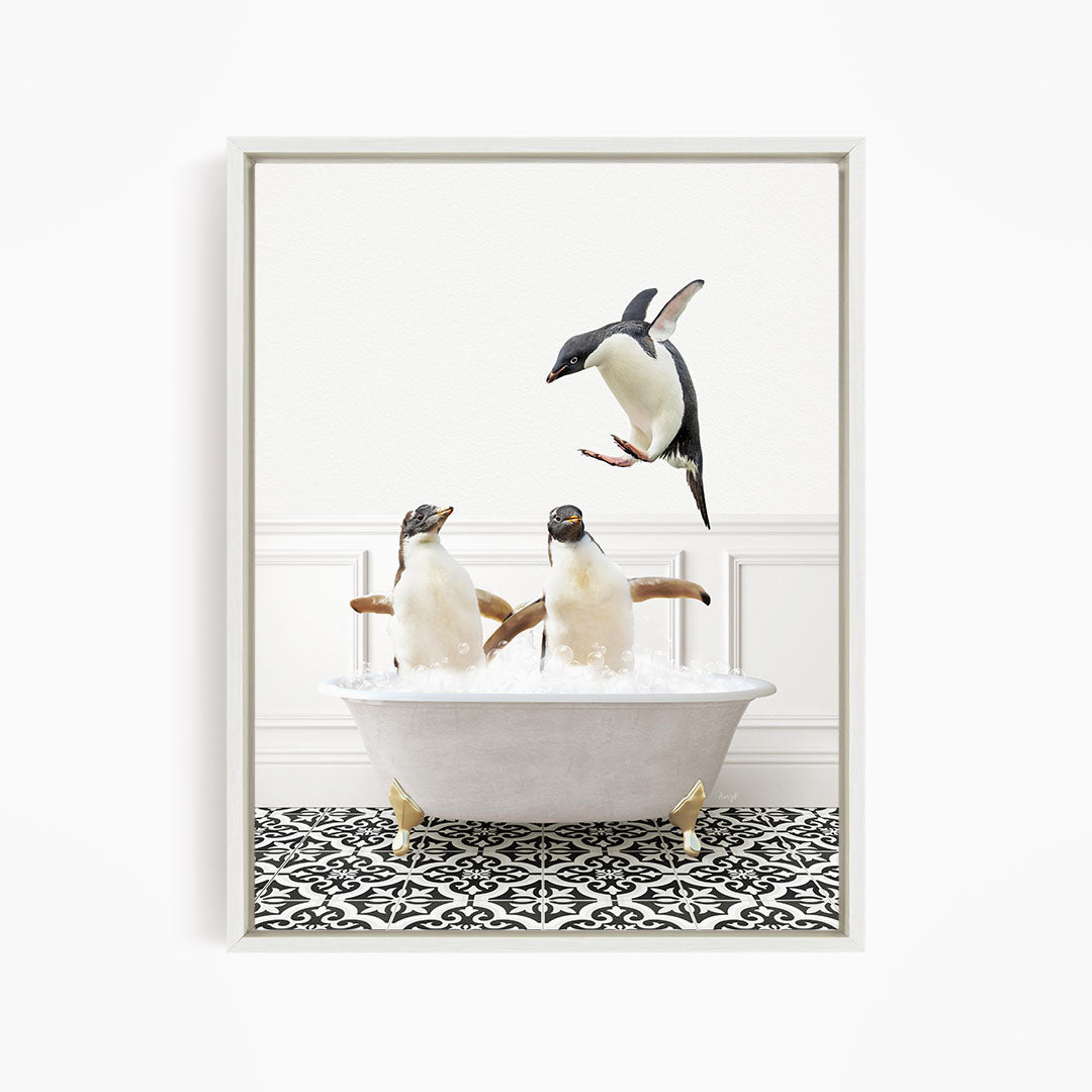 A framed image depicting three penguins in a bathtub, with one penguin jumping out of the tub.