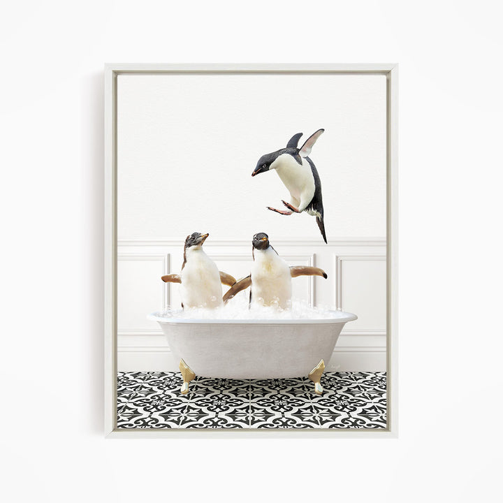 A framed image depicting three penguins in a bathtub, with one penguin jumping out of the tub.