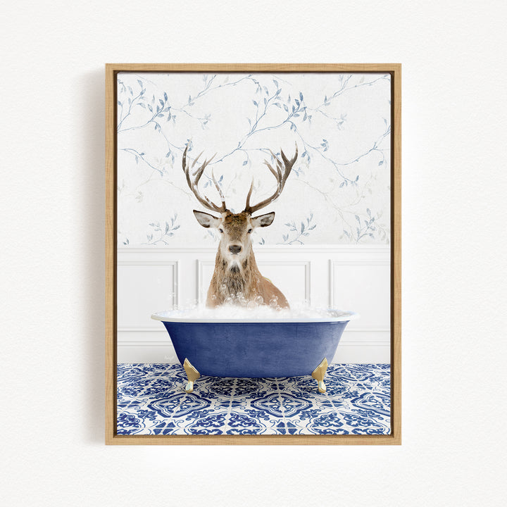 A deer with large antlers is sitting in a blue bathtub filled with water, surrounded by a patterned tile floor.