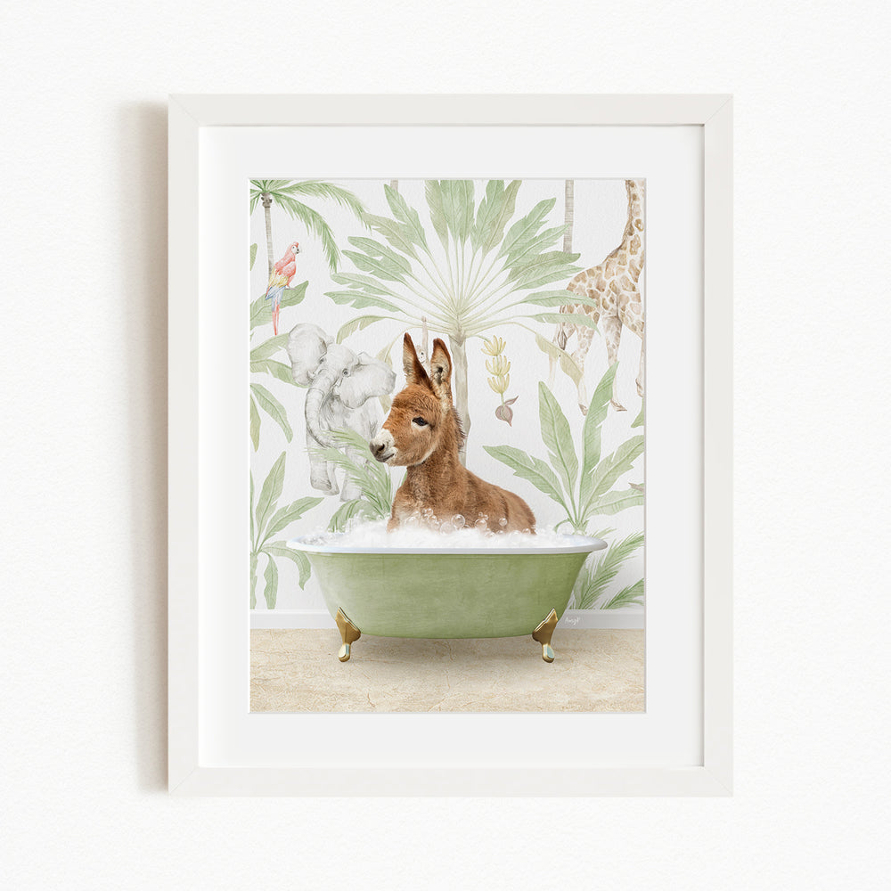 A framed print depicting a donkey sitting in a green bathtub, surrounded by tropical foliage and animals, including a giraffe and a kangaroo.
