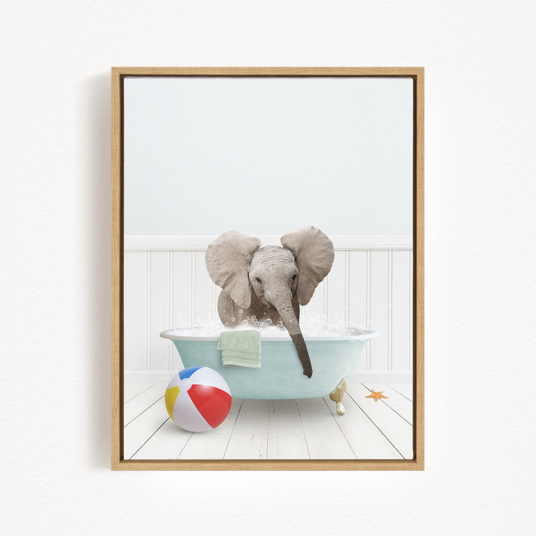 A baby elephant sitting in a bathtub filled with water, surrounded by a beach ball and a towel.