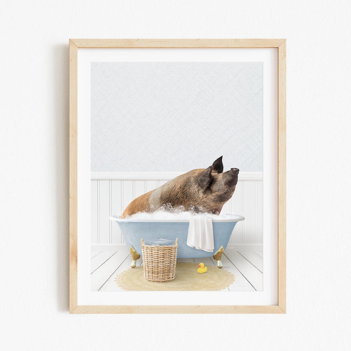 A brown pig sitting in a blue bathtub filled with water, surrounded by rubber ducks and a towel.