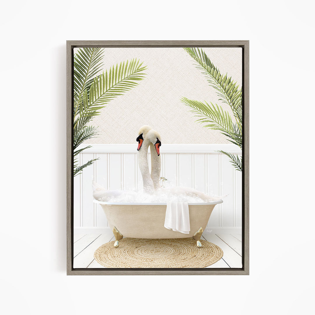 A framed image depicting two swans sitting in a bathtub filled with bubbles, surrounded by green palm leaves.
