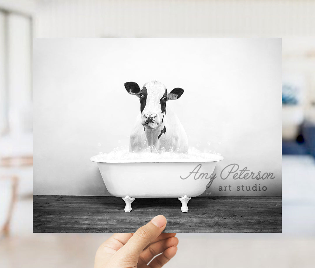 a black and white photo of a cow in a bathtub