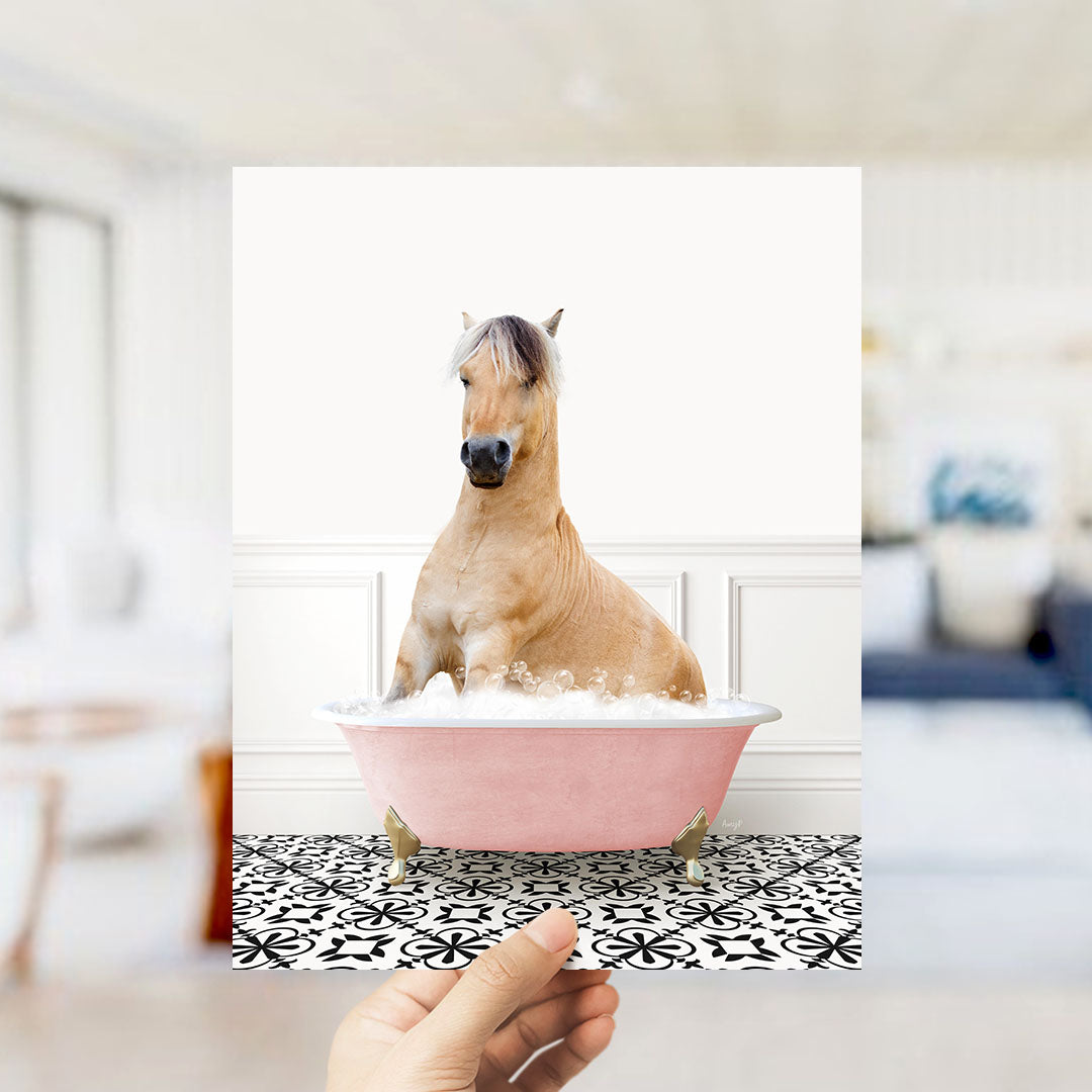 A light brown horse sitting in a pink bathtub filled with water, surrounded by a black and white patterned floor.