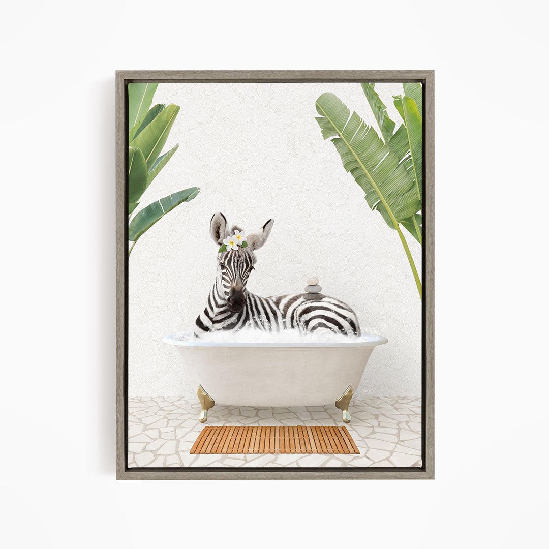 A zebra is sitting in a white bathtub, surrounded by tropical plants and a wooden mat on the floor.