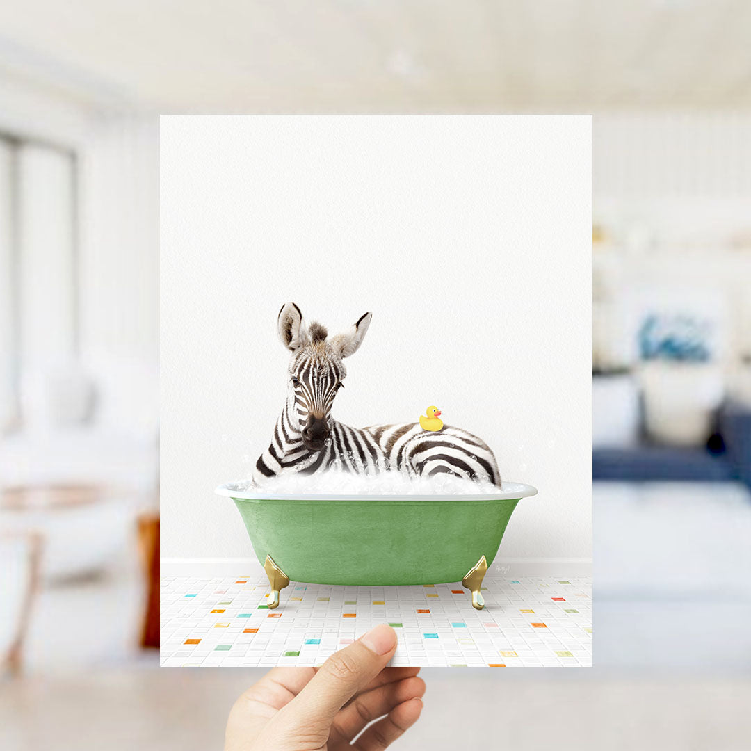 A zebra is sitting in a green bathtub, with a yellow rubber duck resting on its back.