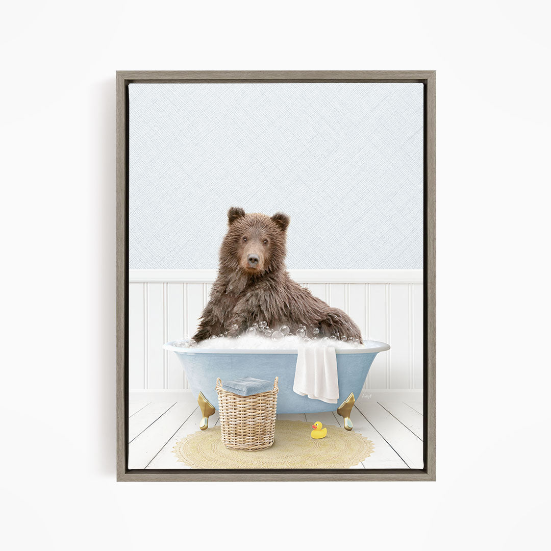 A brown bear sitting in a blue bathtub filled with bubbles, surrounded by rubber ducks and a basket.