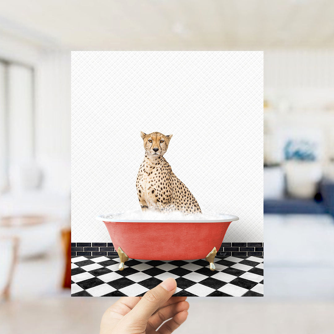 A cheetah sitting in a red bathtub filled with water, as if taking a bath.