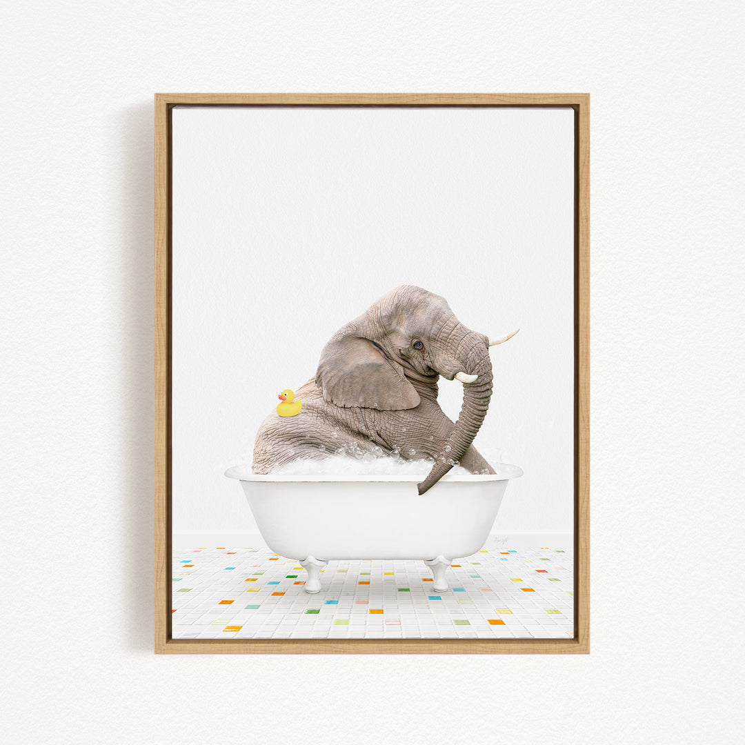 A gray elephant is sitting in a white bathtub, with a yellow rubber duck floating next to it.