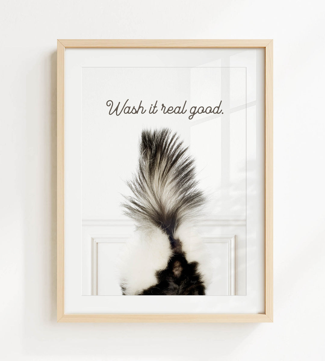 a framed picture of a skunk's tail with the text "Wash it real good."