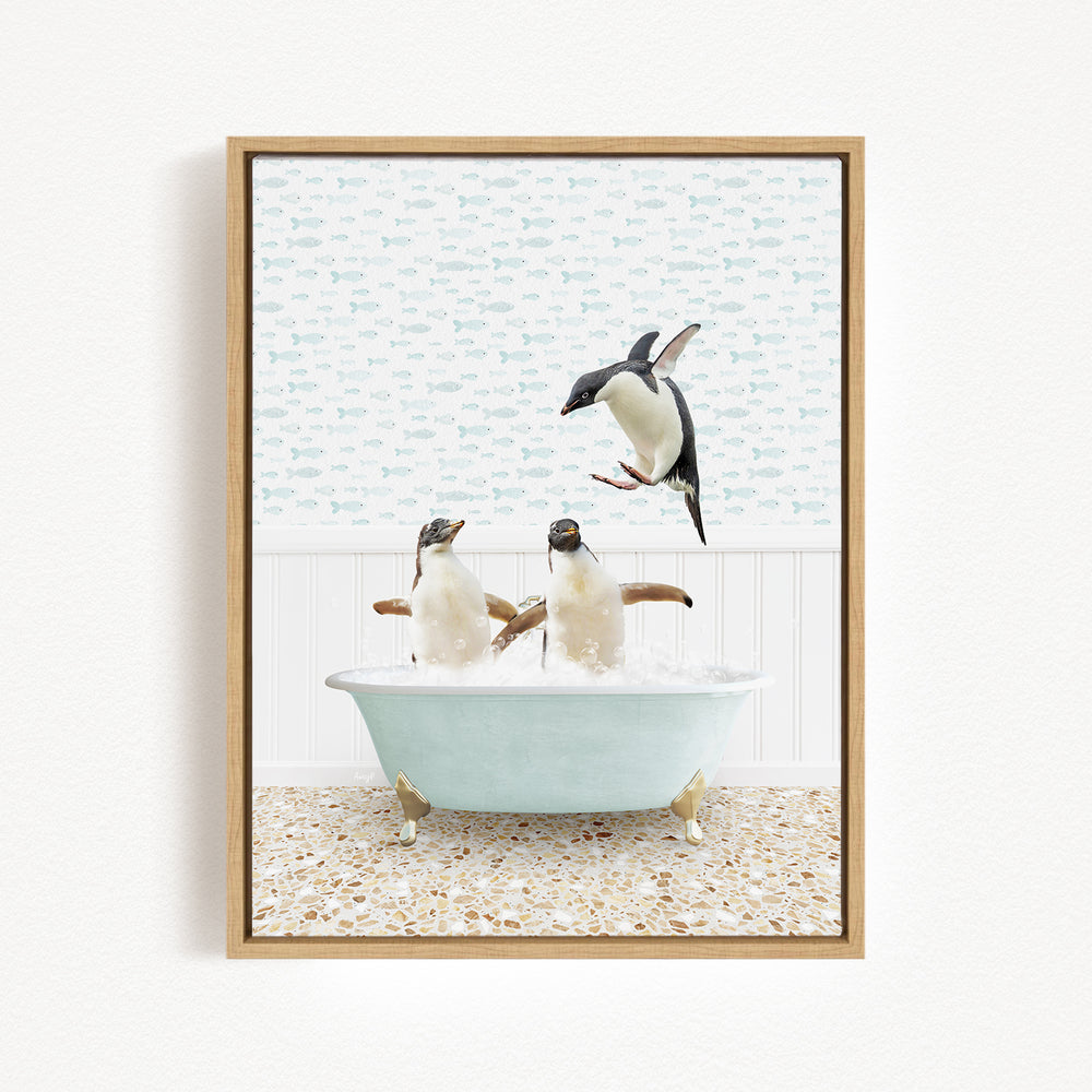 A framed image depicting two penguins sitting in a bathtub, with one penguin jumping out of the tub.