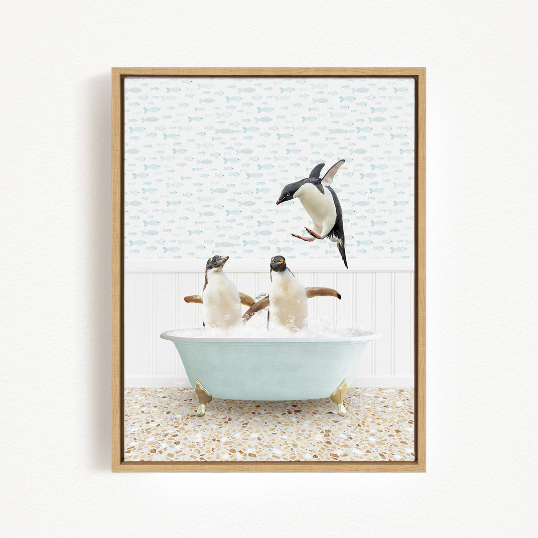 A framed image depicting two penguins sitting in a bathtub, with one penguin jumping out of the tub.