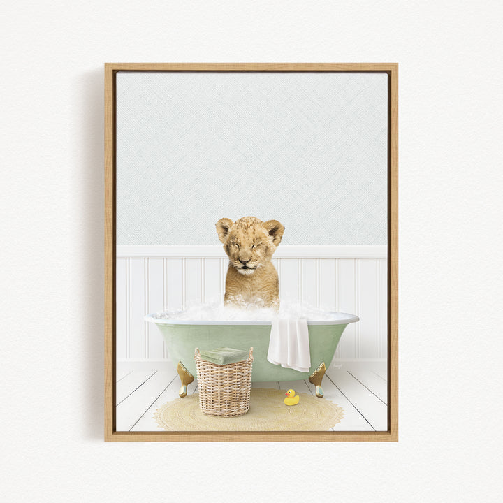 A young lion cub sitting in a green bathtub filled with bubbles, surrounded by rubber ducks and a basket.