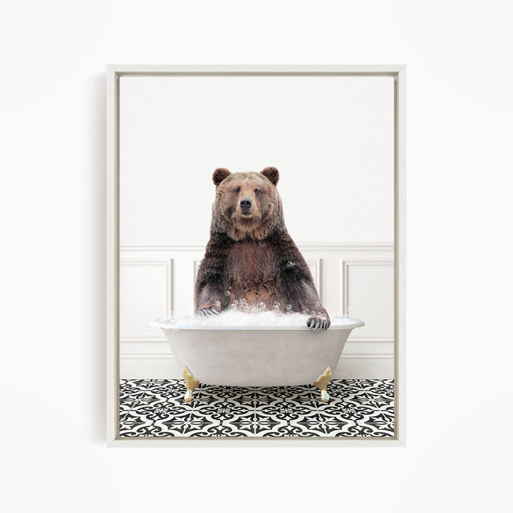 A brown bear sitting in a white bathtub filled with water, surrounded by a black and white patterned floor.