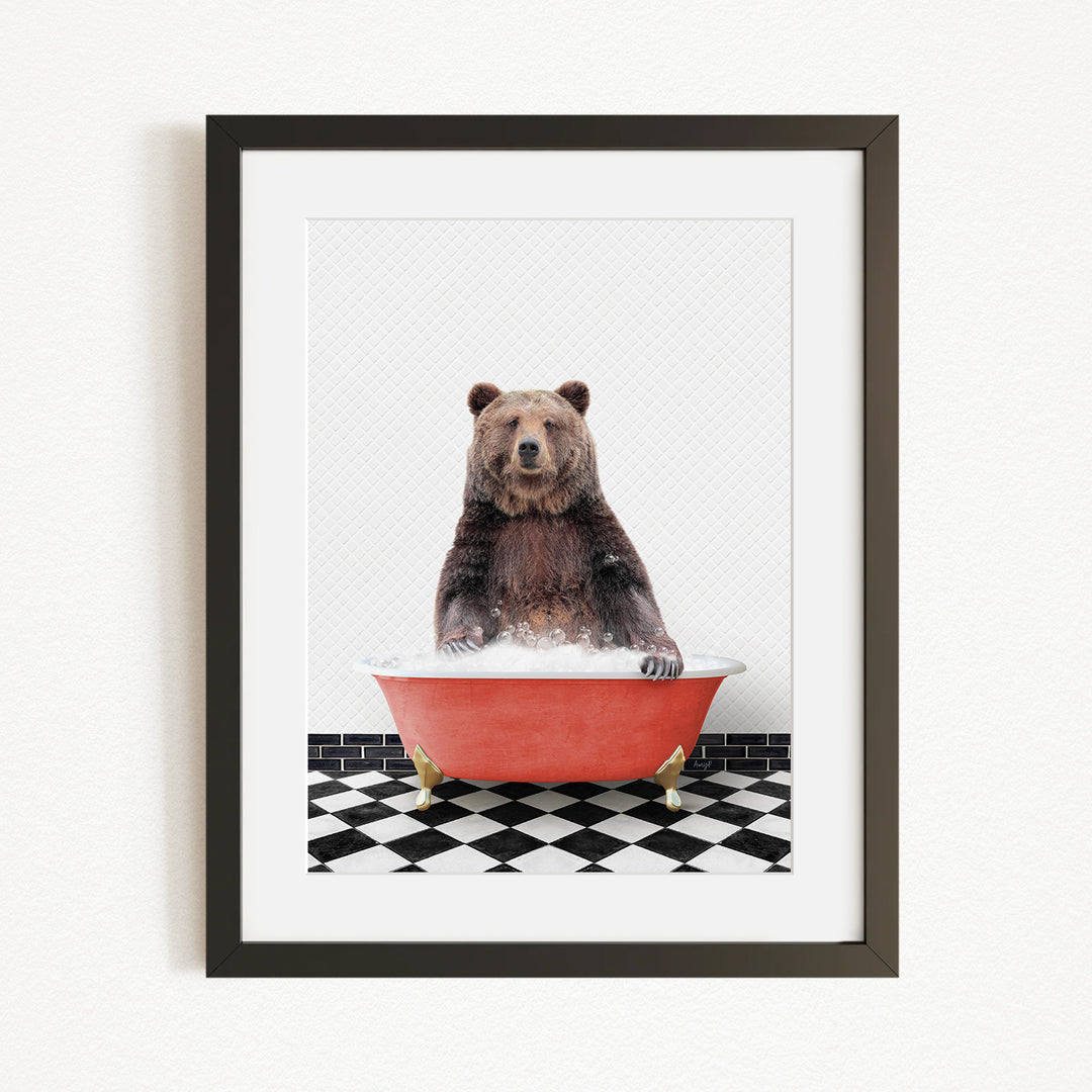 A brown bear sitting in a red bathtub on a black and white checkered floor.