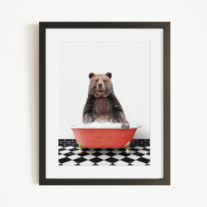 A brown bear sitting in a red bathtub on a black and white checkered floor.