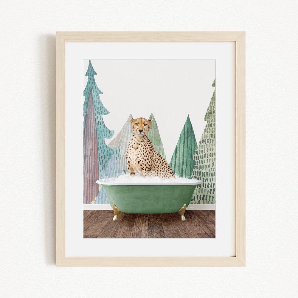 A cheetah is sitting in a green bathtub, surrounded by a forest-themed background with trees and snow.
