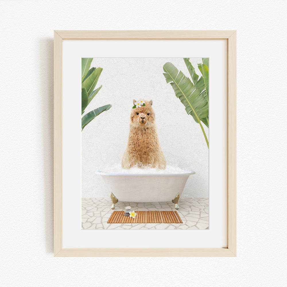 A brown alpaca sitting in a white bathtub, surrounded by green plants, in a framed picture.