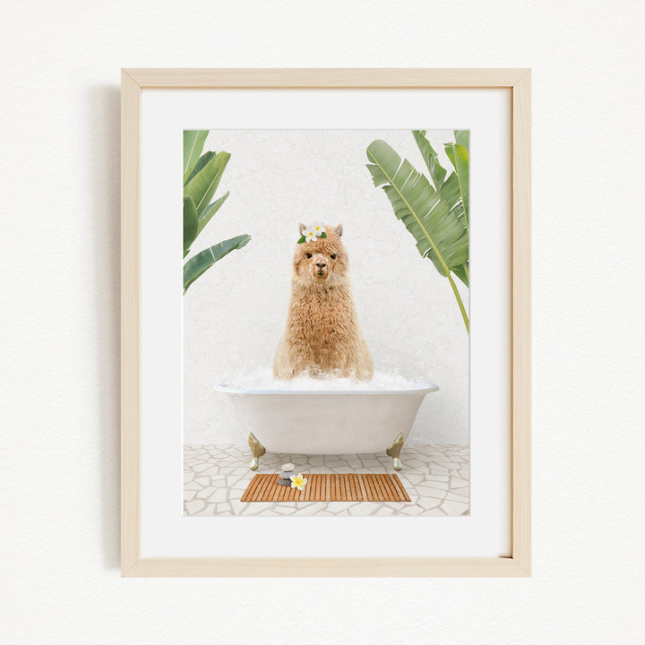 A brown alpaca sitting in a white bathtub, surrounded by green plants, in a framed picture.