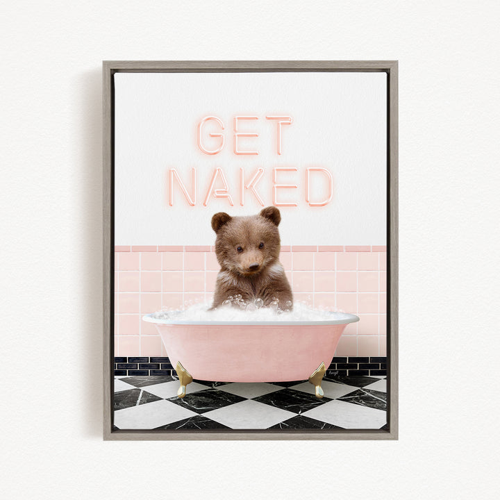 A cute brown bear sitting in a pink bathtub with the text "GET NAKED" displayed above it.