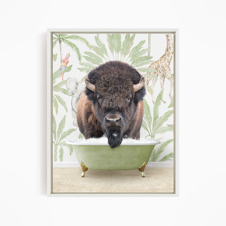 A buffalo is sitting in a green bathtub, surrounded by tropical foliage and a giraffe in the background.