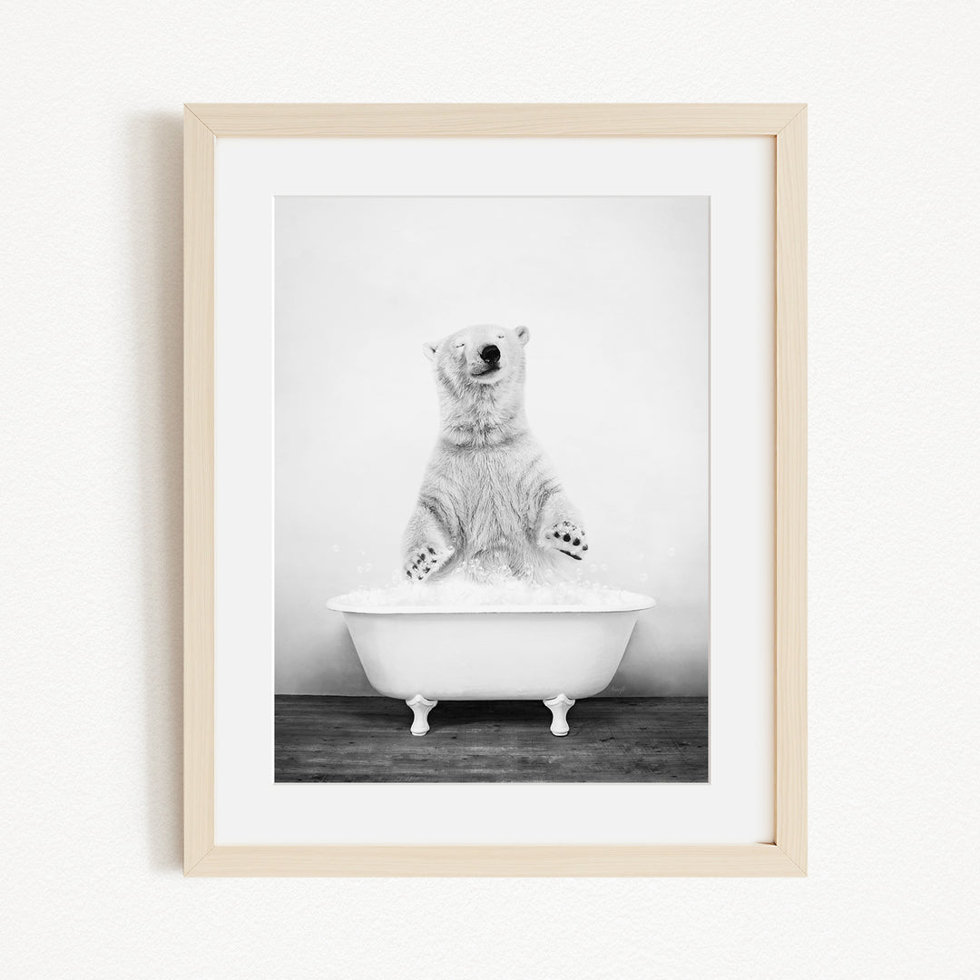 A polar bear standing in a bathtub filled with water, appearing to be enjoying a bath.