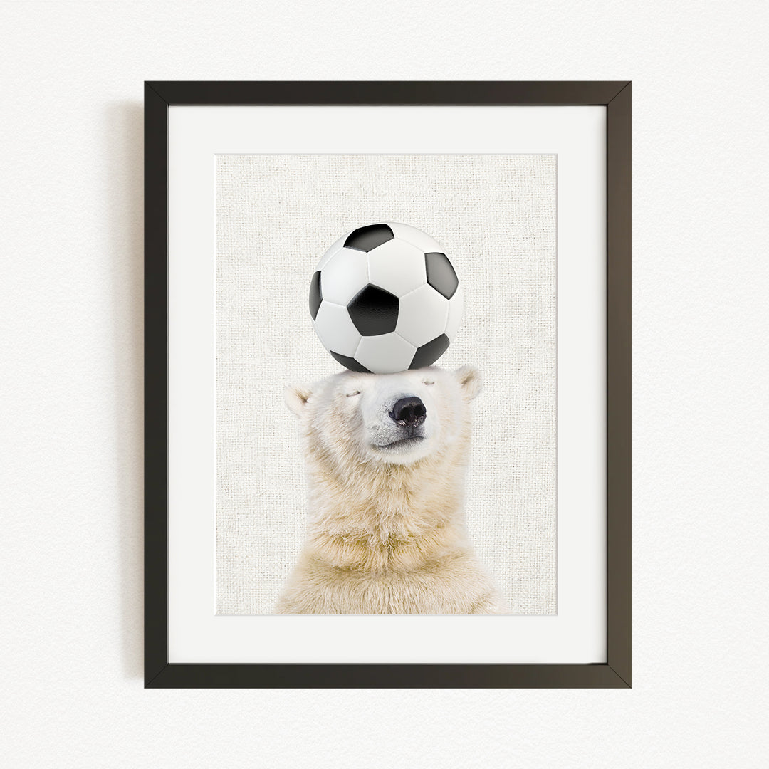 A polar bear balancing a soccer ball on its head.
