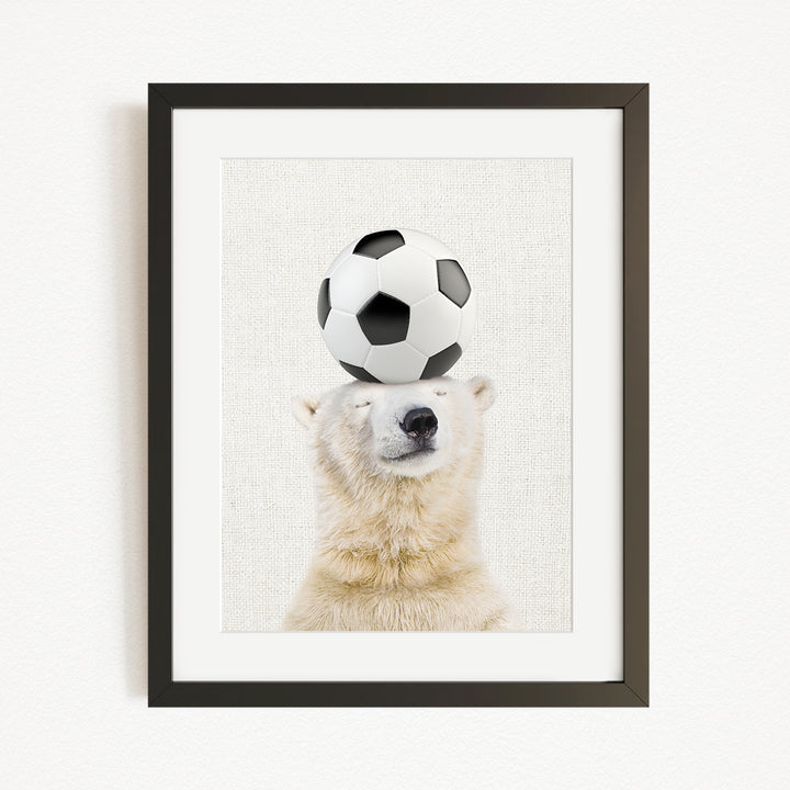 A polar bear balancing a soccer ball on its head.