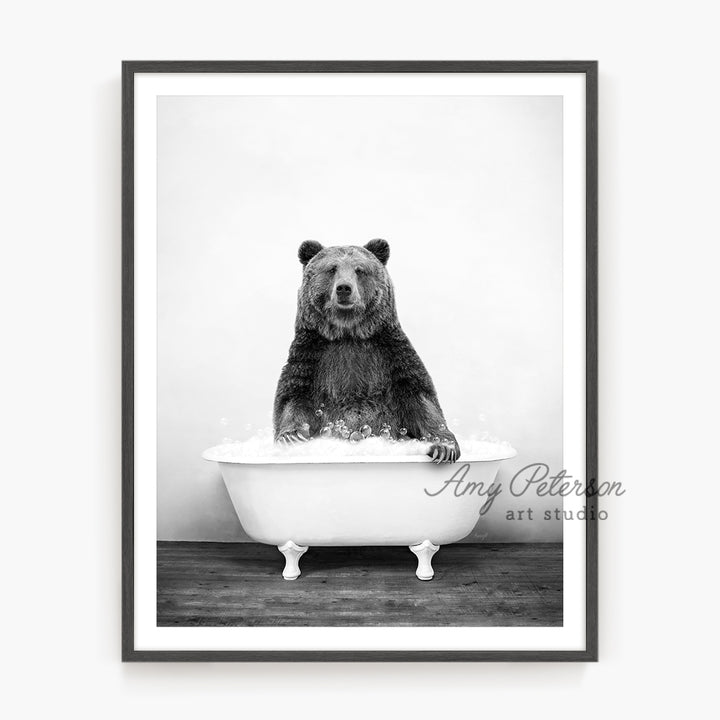 a black and white photo of a bear in a bathtub