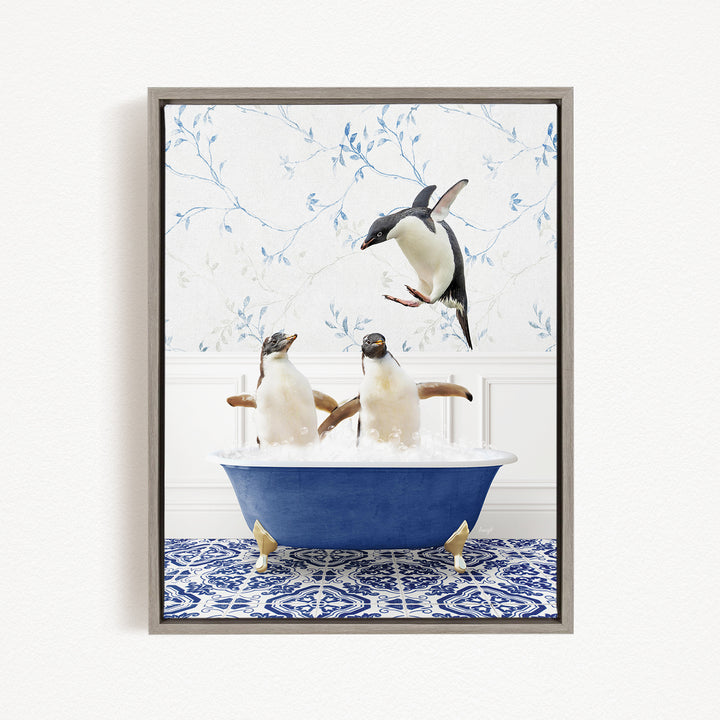 A framed image depicting three penguins sitting in a blue bathtub, with one penguin flying towards the others.